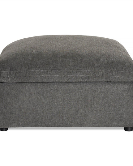 The My Cloud Slope 40 Ottoman offers large, square gray comfort with its cushioned top. It features a sleek fabric finish and short black legs, making it perfect customizable furniture for any living room or lounge with its simple, modern design.
