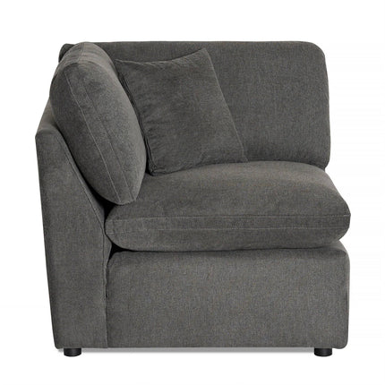 The My Cloud Slope Corner offers a versatile modular design with a dark gray plush L-shaped sectional piece. It includes a matching throw pillow against the upholstered backrest and sits on short, subtle legs. The soft, comfortable fabric makes it an inviting addition to any room.