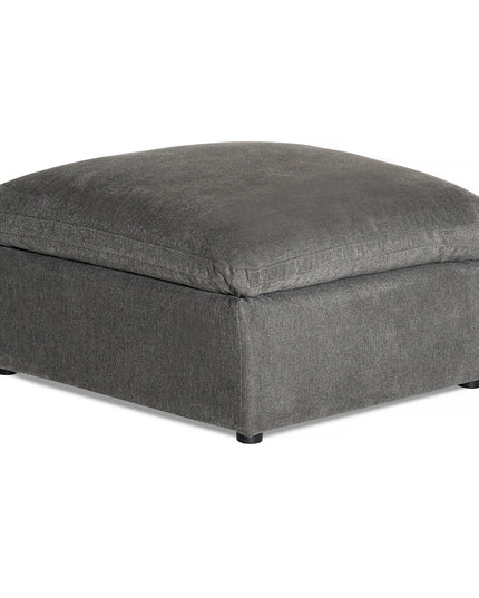 The My Cloud Slope 40 Ottoman features a square, modern design with dark gray fabric and low black feet, offering comfortable elegance. The plush top cushion, matching the base in color and texture, adds a serene touch to any space.