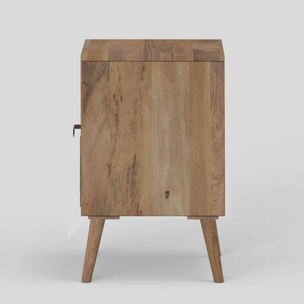 The Mango Geometric Nightstand is a handcrafted wooden piece with a natural finish and minimalist design. It features a single door, four tapered legs, and is made from mango wood with a visible grain that adds rustic, bohemian flair to any space.