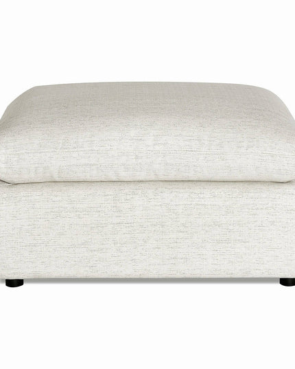 The My Cloud Slope 40 Ottoman, rectangular and light gray, blends comfort and style with its soft cushioned top. Its subtle fabric texture rests on small round black feet, making it a customizable piece suitable for seating or as a footrest.