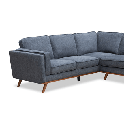 The Maddox LSF is a modern gray sectional sofa featuring plush cushions, wooden legs, and a right-angle design. Its smooth upholstery and sleek, minimalist aesthetic add mid-century modern flair to any contemporary living space.