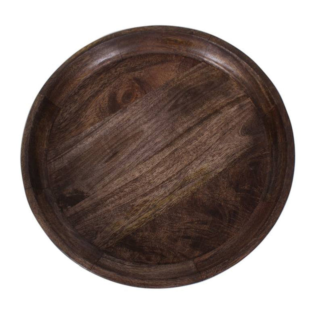 The Mango Bowl Side Table is round and dark, crafted from mango wood with a smooth finish and visible grain patterns. Its shallow depth and subtle edge provide a minimalist, natural look that seamlessly complements mid-century style interiors.