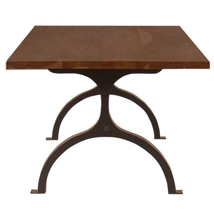 The Acacia Foundry Coffee Table features a thick wooden tabletop with warm, natural tones, resting on an ornate, dark-painted metal base. This vintage-inspired piece showcases a square shape and arched design that creates a beautiful contrast.