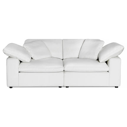 The Peyton 2 Piece Straight is a luxurious white, cushioned two-seater sofa showcasing a smooth, contemporary design. It features plush, slightly reclined backrests and armrests that seamlessly blend with its body, creating a sanctuary of comfort against a plain white background.