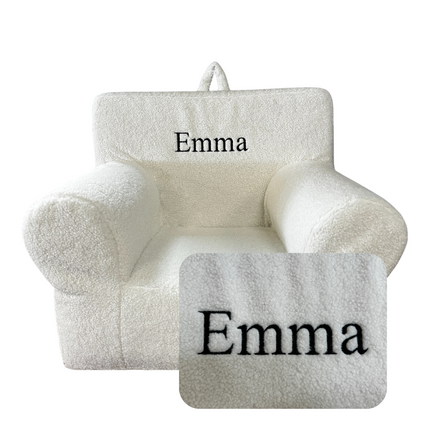 A plush cream My Cloud Kidz Chair made with soft Sherpa fabric features Emma in black embroidery on the backrest, with a close-up showing the intricate detail.