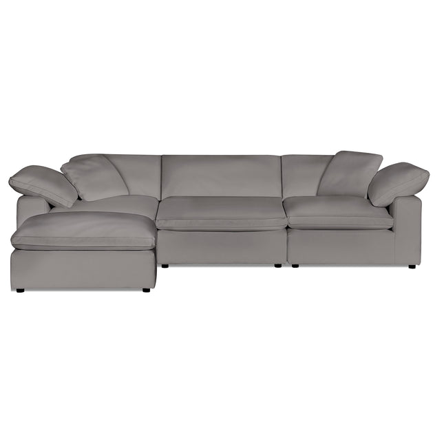 The Peyton 3 Piece Straight+ Ottoman is a spacious light gray sectional with a left-side chaise. Its wide armrests and cushioned seats and backs offer luxurious comfort, creating an inviting space for relaxation and socializing.