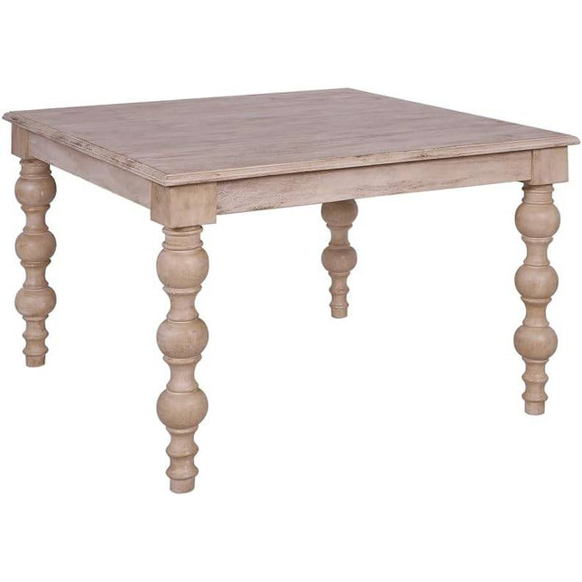 The French Country Square 48 Dining Table is crafted from solid mango wood with a distressed natural finish and features four intricately carved legs for a French-country-inspired elegance.