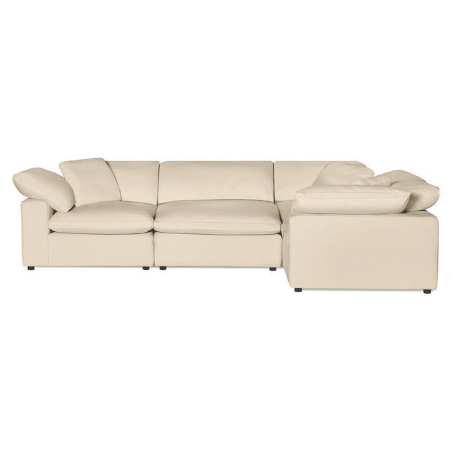 The Peyton 4 Piece Right L is a luxury cream leather sectional sofa with three seats and a chaise on the right. It features plush cushions, low-profile armrests, and fits seamlessly into modern living rooms, all set against a plain white background.