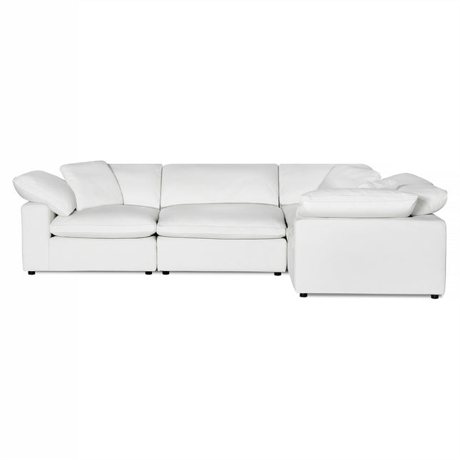 The Peyton 4 Piece Right L is a luxurious L-shaped sectional with plush cushions, low armrests, and small black feet, creating a comfort sanctuary against a white backdrop.