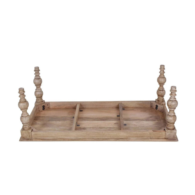 The French Country Coffee Table features an upside-down design with ornate, carved legs for charm. Its rectangular tabletops underside shows a simple frame construction, while the solid mango wood has a distressed natural finish, enhancing its rustic appeal.