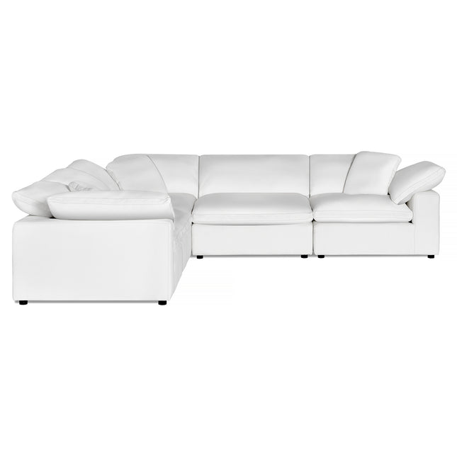 The Peyton 5 Piece L sectional, a large white leather sofa with plush cushions, offers luxurious comfort against a plain backdrop. Its right-angle design ensures ultimate adaptability to any space.