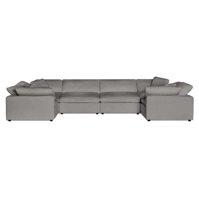 The Peyton 6 Piece Pit is a gray, modular L-shaped sofa featuring plush cushions and wide armrests for ultimate comfort. Its contemporary design boasts clean lines and a spacious seating area, adaptability to any space, and a luxurious cushioned backrest, all set against a plain white background.