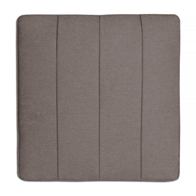 With its vertical seams, the gray square seat cushion perfectly complements the Millenium Ottoman against a white backdrop, showcasing modern luxury.