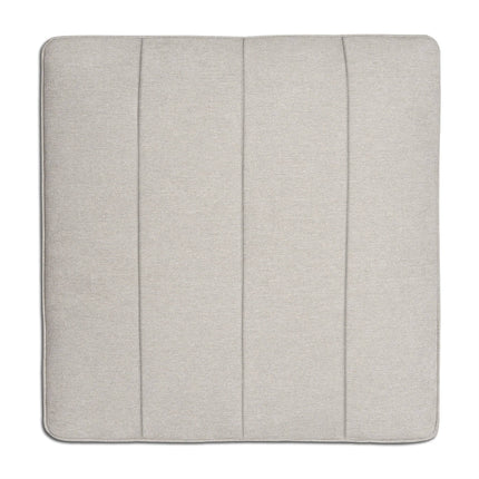The Millenium Ottoman features a square, light gray seat cushion with visible seams that form three vertical panels, enhancing its modern luxury appeal. The smooth, soft fabric promises comfort and simplicity, making it perfect for any modular sofa setup.