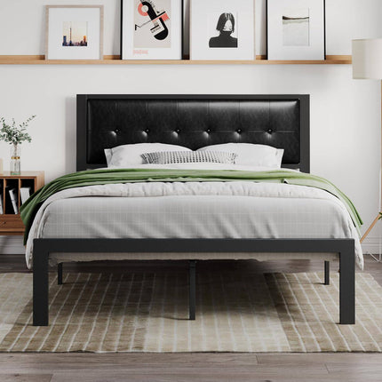The modern bedroom includes the cost-effective Modena Platform Bedframe in black leather, accented by white and gray bedding with a green throw. Artwork hangs above, while a wooden nightstand with a plant and floor lamp accompany it. A striped rug complements the sturdy wooden floor.