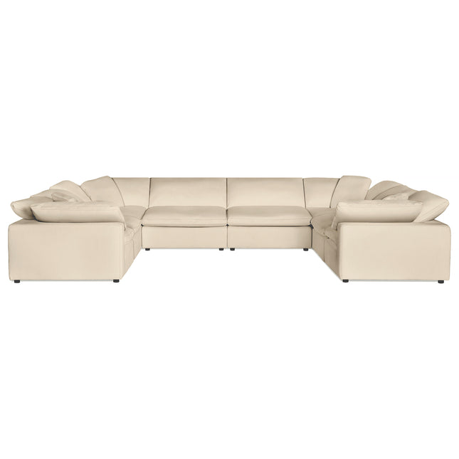 The Peyton 8 Piece Pit luxury sectional is a large, beige, U-shaped sofa with cushioned seats and backs, low armrests, and small black feet. It exudes modern elegance and spacious comfort, balancing style with adaptability for any living space.