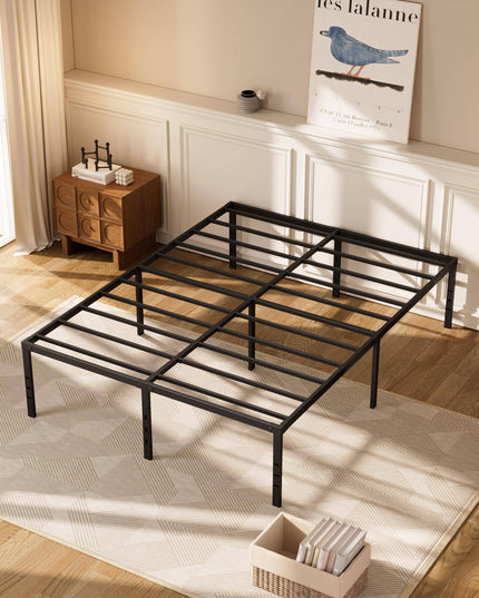 A minimalist bedroom showcases an empty black My Cloud Mattress Platform on a light geometric-patterned rug. Wooden side tables with decor adorn the walls, while a bird poster hangs above one table. Large windows flood the room with bright natural light.