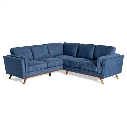 The Maddox Sectional is an elegant blue L-shaped sofa with plush cushions and wooden legs, ideal for any living room. With its modern silhouette and upholstered fabric, it brings a mid-century modern flair. Shown on a white background for clarity.