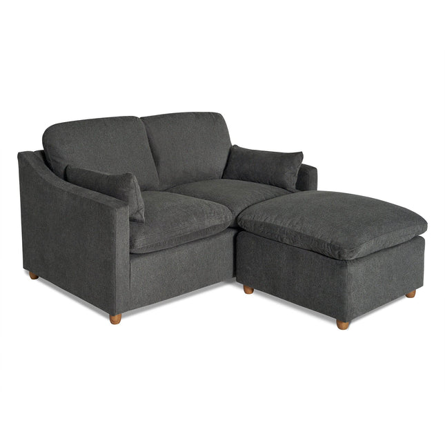The My Cloud Slope Loveseat, in dark gray upholstery with square arms, features an accompanying matching ottoman on the right. Both pieces offer a plush look and stand on small wooden legs, combining style with durable furniture design.