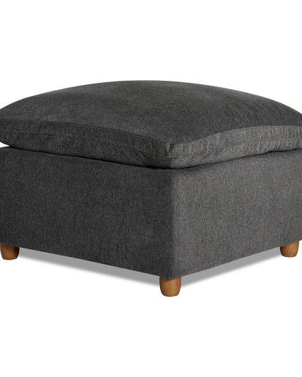 The My Cloud Slope 30 Ottoman features a plush gray upholstered cushion and small wooden legs. Its simple, modern design complements various home decor styles, offering both comfort and customizable furniture options for your living space.