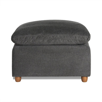 The My Cloud Slope 30 Ottoman, in a square shape and dark gray fabric, features a cushioned top for style and comfort. Supported by four short wooden legs and set against a white backdrop, it exemplifies customizable furniture at its finest.