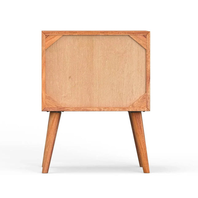 The MCM Bedside Table, crafted from solid mango wood, features a plain front panel and stands on four tapered legs, shown against a white background in a mid-century modern style.