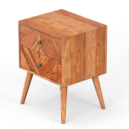 The MCM Bedside Table is crafted from solid mango wood and boasts a mid-century modern design. It features two drawers with circular brass knobs, angled legs for stability, and its natural grain adds understated elegance to any bedroom decor.