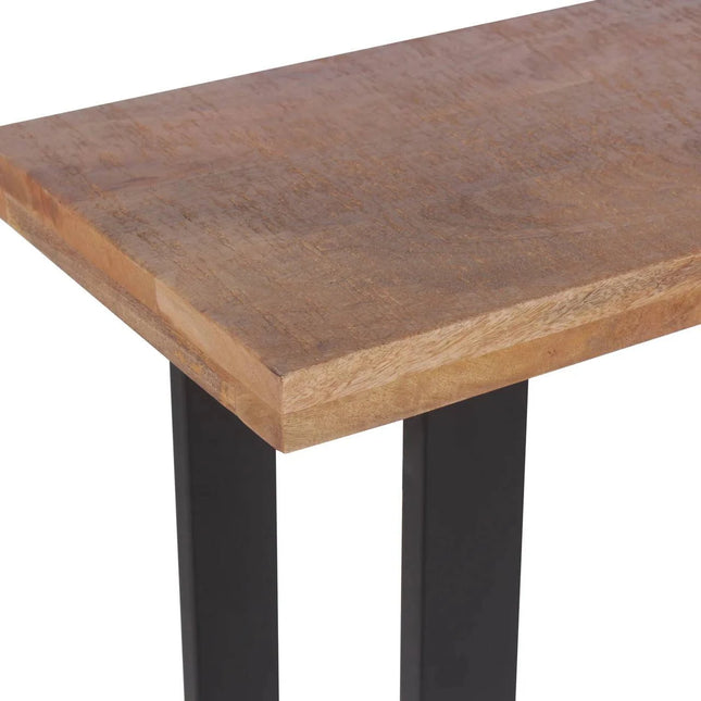 Close-up of the Mango Console, a rectangular table crafted from mango wood with a smooth surface and natural grain. Its eco-friendly design includes sleek black metal legs for a modern, minimalist look, ideal for contemporary dining rooms. Focus is on the textured tabletop edge.