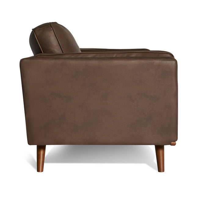 The Maddox Chairs side view features a rectangular backrest and seat cushion in mid-century modern brown leather, with wooden legs. Its simple design on a white background offers style and comfort, making it the perfect match for the Maddox Sofa Set.