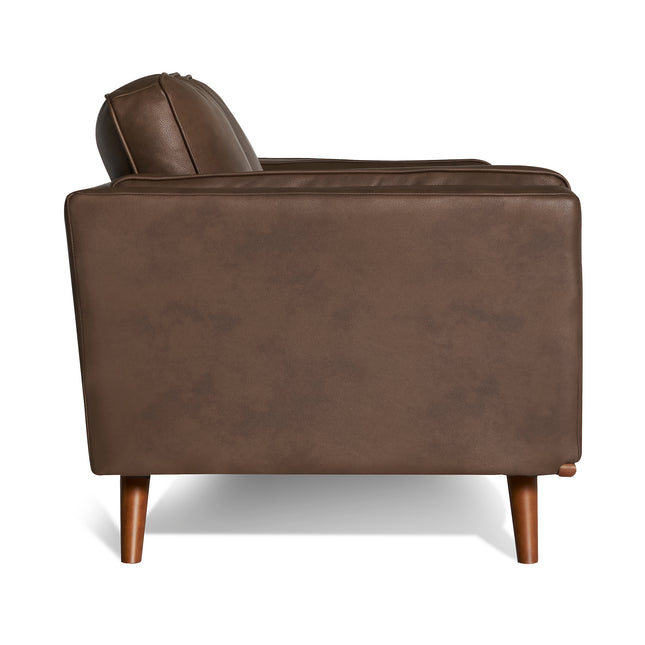 Side view of the Maddox Loveseat, a brown leather piece with a boxy, mid-century modern design. It features a cushioned backrest and seat on wooden legs, showcasing durable construction against a white background.
