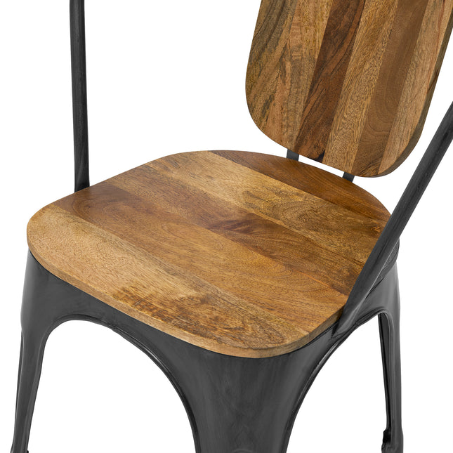 The Mango Barrel Chair features a close-up view of its wooden seat and backrest that highlights natural grain patterns. Its sustainable, handcrafted design combines warm mango wood tones with an industrial black metal frame for an elegant look.