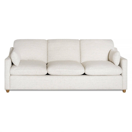 The My Cloud Slope Sofa is a minimalist white piece with three seat and back cushions. Its design includes short wooden legs, two bolster pillows, and machine-washable covers for easy maintenance.