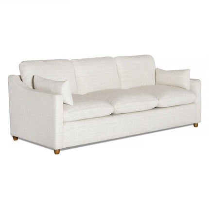 The My Cloud Slope Sofa is a three-seater with light beige fabric, plush cushions, matching throw pillows, curved armrests, and wooden legs. Its machine-washable covers add practicality to its style.