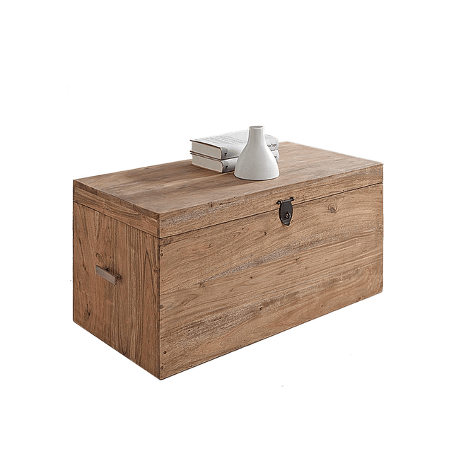The Rustic Wooden Chest features a hinged lid and metal handle, complete with a small front lock. Topped with books and a minimalist white vase, its natural wood finish remains unpolished for an authentic rustic look.
