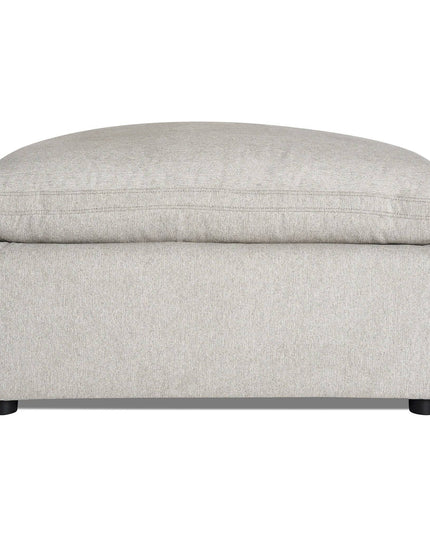 Meet the My Cloud 40 Ottoman, a comfy furniture piece in light gray with a plush cushioned top and minimalist black legs. Its soft, textured fabric enhances its modern and cozy look—perfect for any living space.