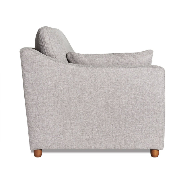 Side view of the light gray My Cloud Slope Chair featuring a cushion, slightly angled backrest, and wooden legs for a modern, minimalist look epitomizing comfort.