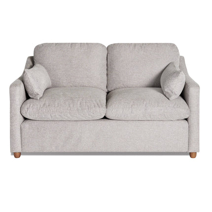 The My Cloud Slope Loveseat, part of the customizable collection, is a light gray upholstered piece with wooden legs. It features two cushions, armrests, and two small side pillows for a cozy look against a white background.