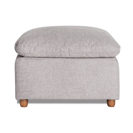 The My Cloud Slope 30 Ottoman in gray features a cushioned top and wooden legs, offering a blend of comfort and modern design. Its textured fabric enhances both style and comfort.