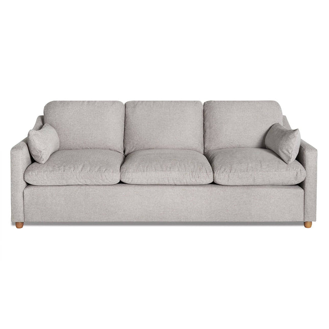 The My Cloud Slope Sofa is a sophisticated light gray three-seater with three seat and back cushions, square armrests, and two matching accent pillows. It sits gracefully on wooden legs, with machine-washable covers ensuring easy maintenance for this customizable piece of furniture.