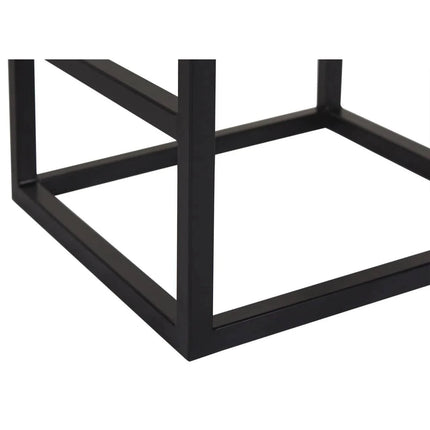A close-up of the Rosewood Stools black metal frame shows intersecting straight lines forming a right angle. This handcrafted frame enhances sturdiness, contributing to a minimalist geometric design against a plain white background.