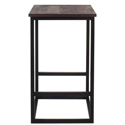This tall, rectangular bar table features a dark wooden top and black metal frame, exuding minimalist luxury with its handcrafted design. The industrial look is completed with four straight legs connected by horizontal supports, pairing perfectly with Rosewood Stools.