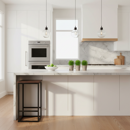 Rosewood Stool tucked under a modern marble kitchen island with pendant lights and plants