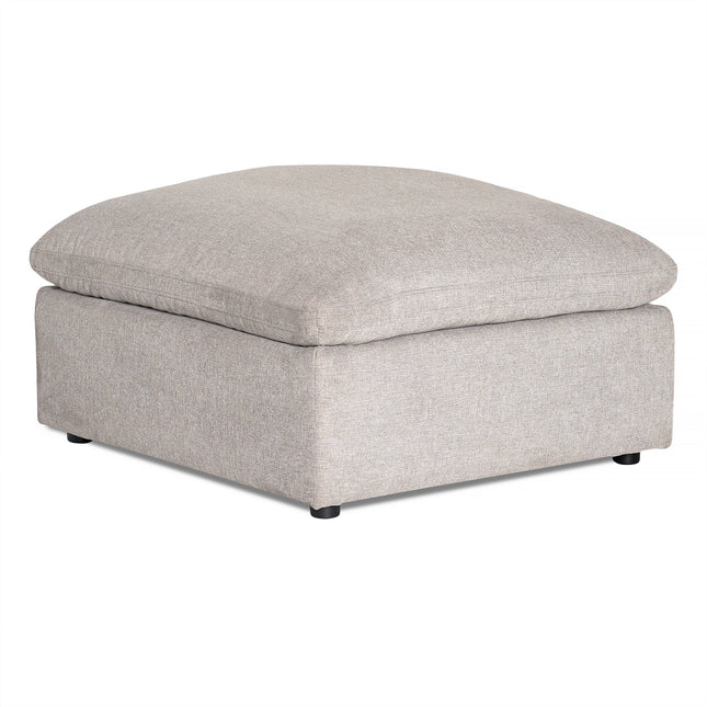 The My Cloud Slope 40 Ottoman offers cloud-like comfort with its cushioned top. Featuring a simple, boxy design, it rests on short black feet and boasts a textured light grey fabric finish, perfect for those seeking cozy furnishings.