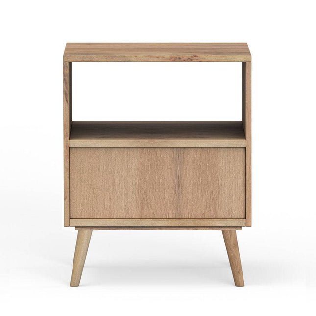 The Mango Geometric Nightstand is handcrafted from mango wood, featuring a minimalist design with an open top shelf, closed lower compartment, and four tapered legs. Its light finish adds bohemian flair, offering a natural and modern aesthetic.