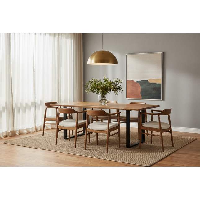 Live Edge acacia dining table staged in a warm modern dining room with wood chairs, brass pendant light and greenery