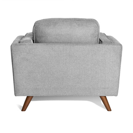 The Maddox Chair is a light gray fabric armchair showcasing a clean, mid-century modern design from the back. It features tapered wooden legs and plush backrest cushions, offering a minimalist yet elegant look akin to the Maddox Sofa Set.