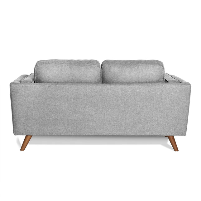 The image features the Maddox Loveseat from the back, highlighting its gray upholstery with two cushions, clean lines, durable build, and four wooden legs, exuding a timeless mid-century modern style.