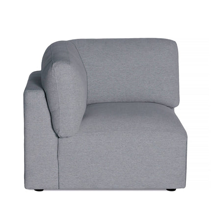 The side view of the Lugano Corner, a modern minimalist gray sectional sofa, showcases its boxy design. Made from premium materials, with thick cushions and a straight backrest, it offers configuration options that boost its contemporary charm in any stylish living space.