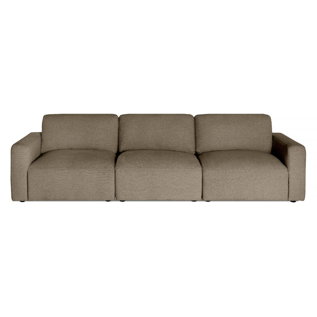 The Lugano sofa embodies Italian luxury with its minimalist design, featuring plush cushions in light brown fabric, distinct seating areas, a low backrest, and wide armrests for comfort and style.